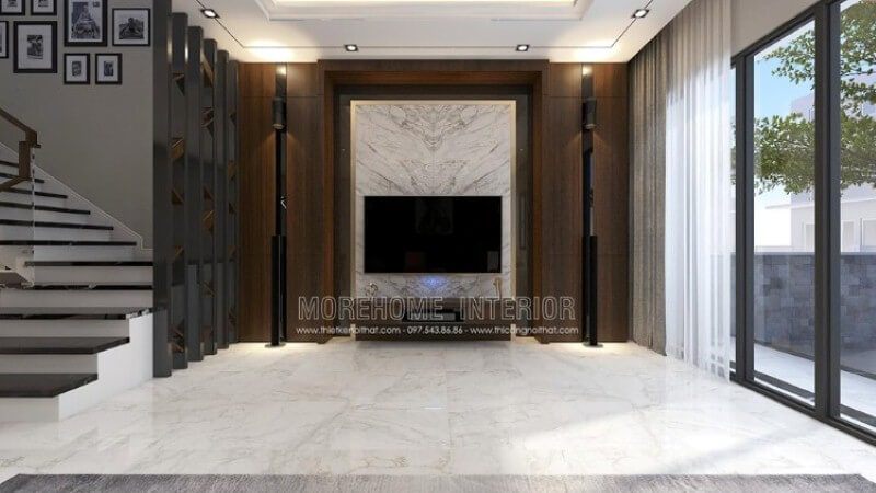 Trang trí nội thất phòng khách đẹp, sang trọng với ý tưởng sử dụng khối đá trắng lớn đối vân ốp tường phòng khách được tôn lên bởi vẻ đẹp trầm từ mảng tường gỗ.