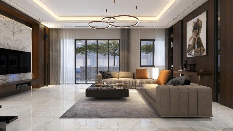 Mẫu bố trí nội thất phòng khách biệt thự cao cấp sử dụng phong cách trang trí nội thất hiện đại cùng cách trang trí đặc biệt khi sử dụng gỗ ốp tường vật liệu đòi hỏi năng lực thi công chuyên nghiệp cùng sự đầu tư không nhỏ từ khối đá đối vân, nền lớn đá.